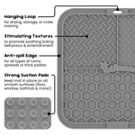 Grey silicone lick mat features showing hanging loop, stimulating textures, anti spill edge and strong suction pads 