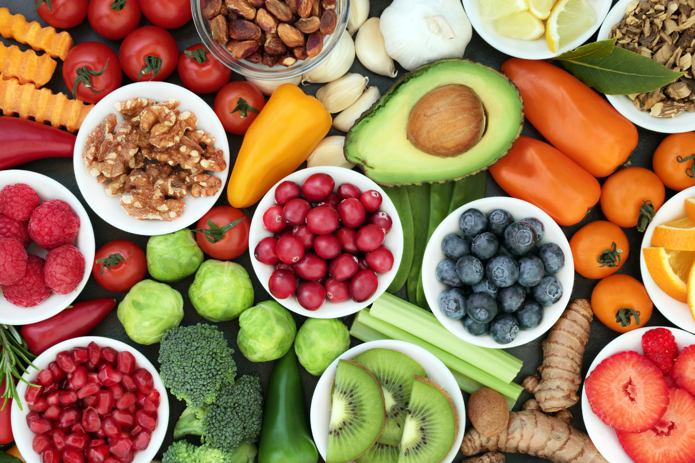 Assorted fruits, vegetables, and nuts on a colorful background