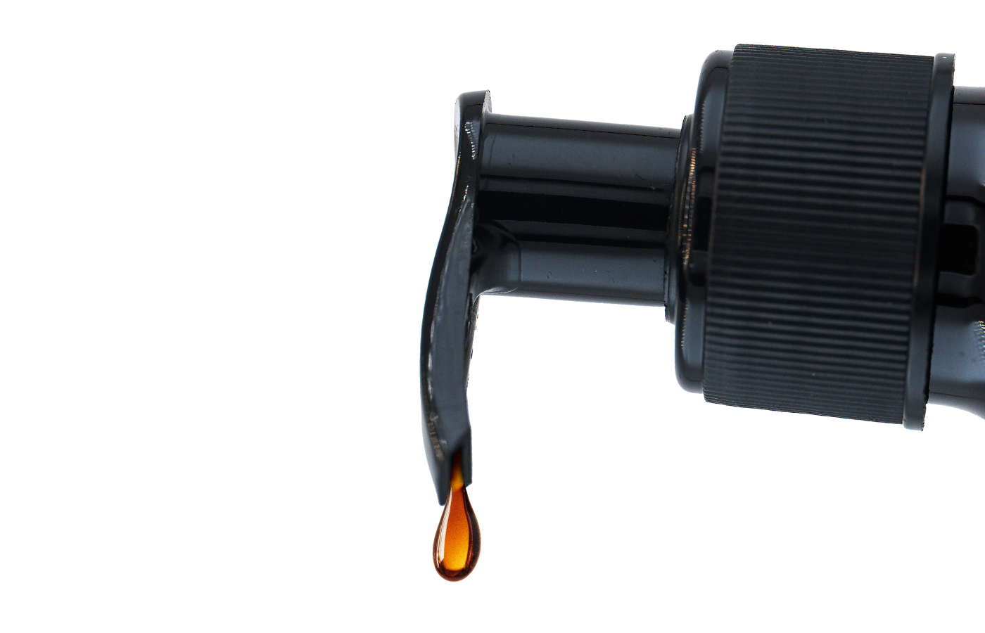 Black bottle with salmon oil dripping against a white background